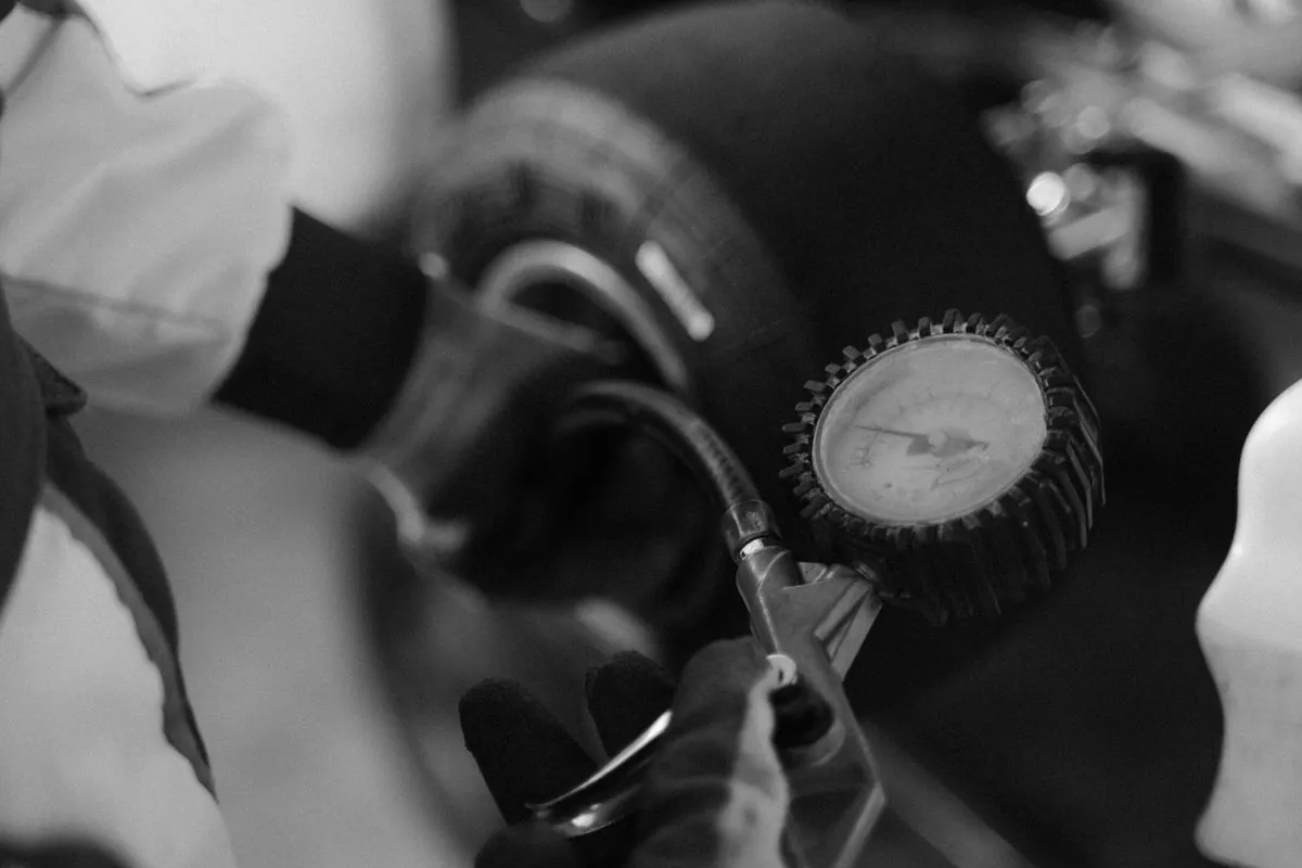 A wheel and tyre being balanced with small weights on the rim