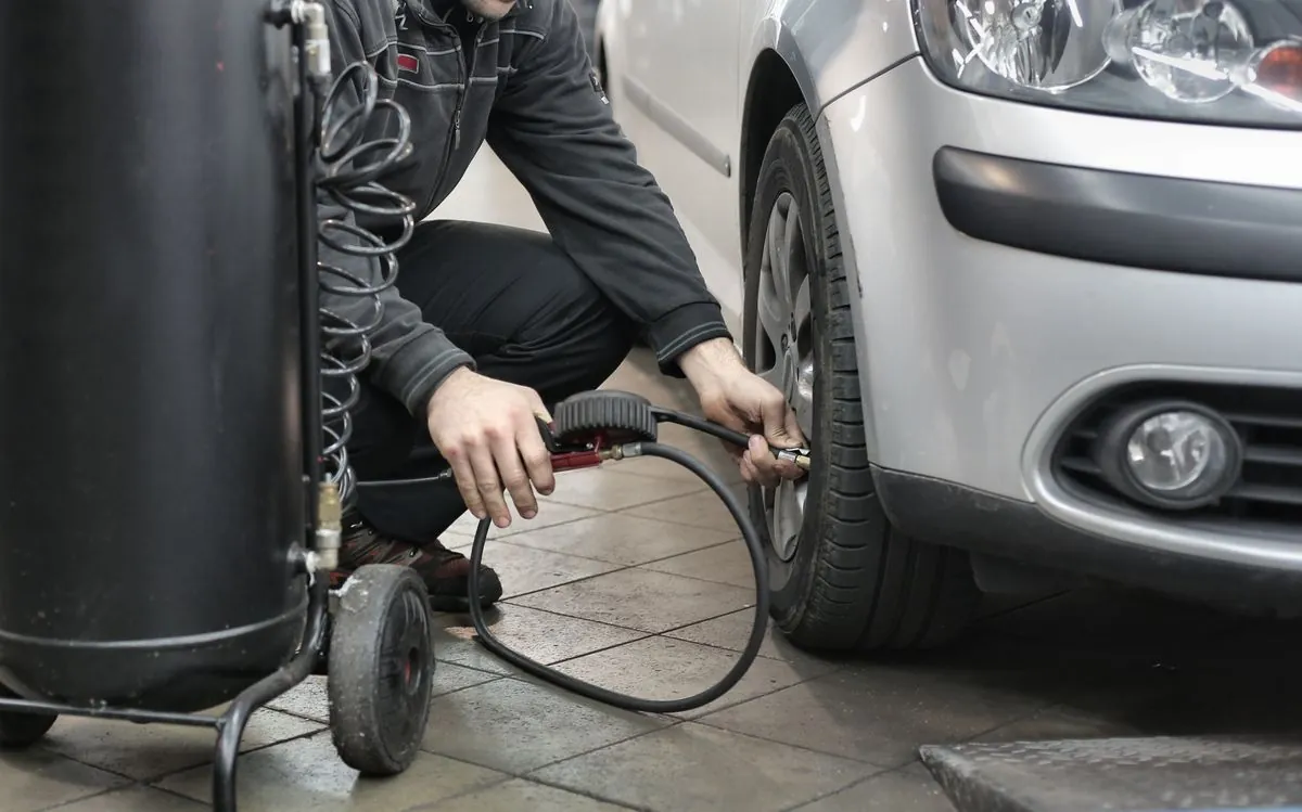 A tyre pressure monitoring sensor being serviced by a fitter