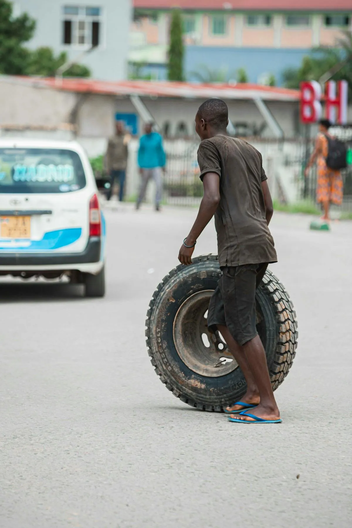 A roadside tyre sealant kit being used on a punctured car tyre