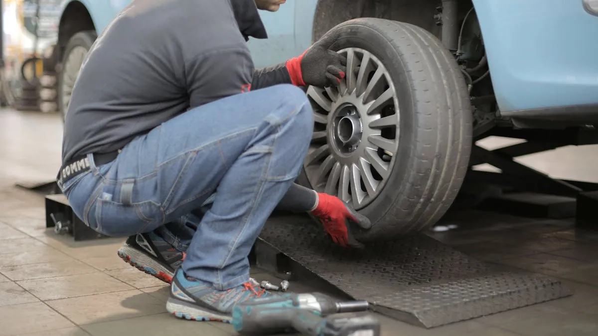 A tyre fitter inspecting a wheel and tyre during a fitting