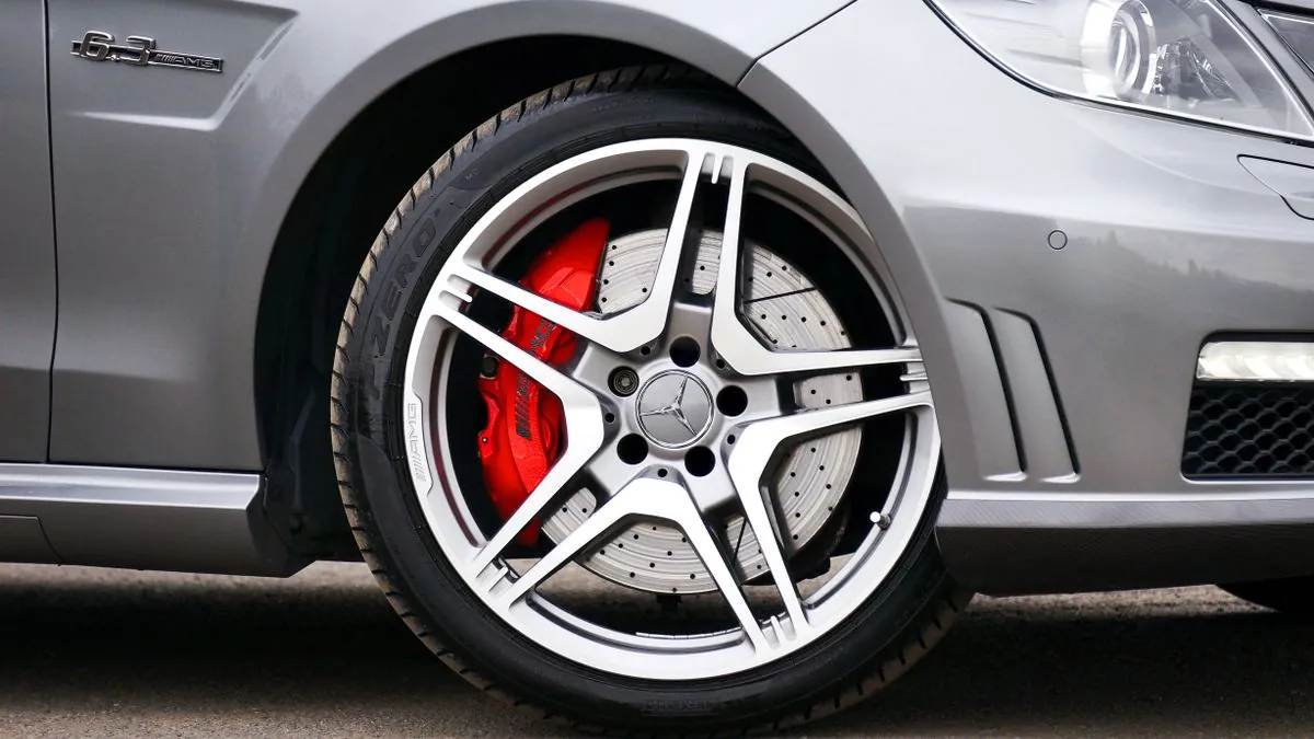 A customer asking a tyre fitter questions before buying