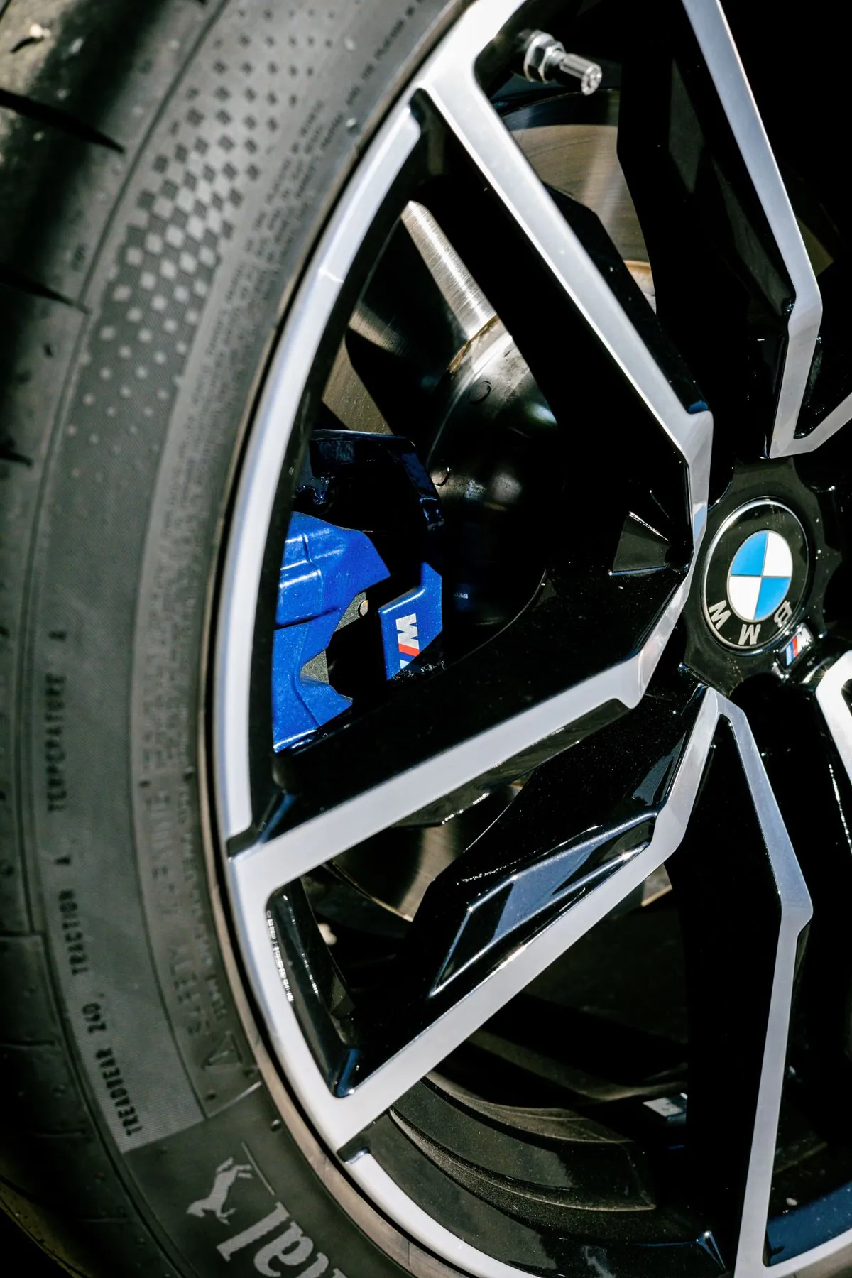 A car wheel and tyre with visible damage that would be illegal to drive on